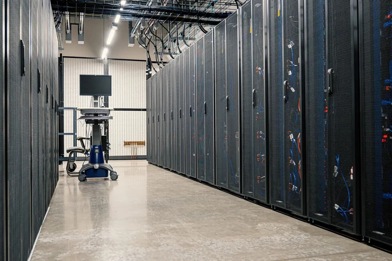 Server cabinets in a data centre aisle — Odoo Community can be deployed on your own infrastructure inside Kuwait